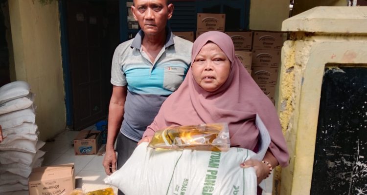 Caption : Warga Desa Rengasdengklok Selatan menerima bantuan beras dan minyak goreng dalam program BPNT-PKH Tahun 2026 yang disalurkan di Dusun Warudoyong Selatan, Kecamatan Rengasdengklok, Kabupaten Karawang. (Foto: Patriotjabar.com/Gugun)