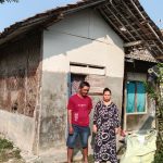 Caption : Suryadi bersama istrinya berdiri di depan rumah mereka yang kondisinya sangat memprihatinkan di Dusun Tegalasem, RT 14/RW 06, Desa Kertasari, Kecamatan Rengasdengklok, Kabupaten Karawang. Dinding bilik yang lapuk, atap yang rusak, serta struktur bangunan yang nyaris roboh membuat keluarga tersebut hidup dalam kekhawatiran. Mereka berharap Pemerintah Kabupaten Karawang segera merealisasikan bantuan melalui program Rumah Tidak Layak Huni (Rutilahu). (Foto: Gunawan/Patriotjabar.com)